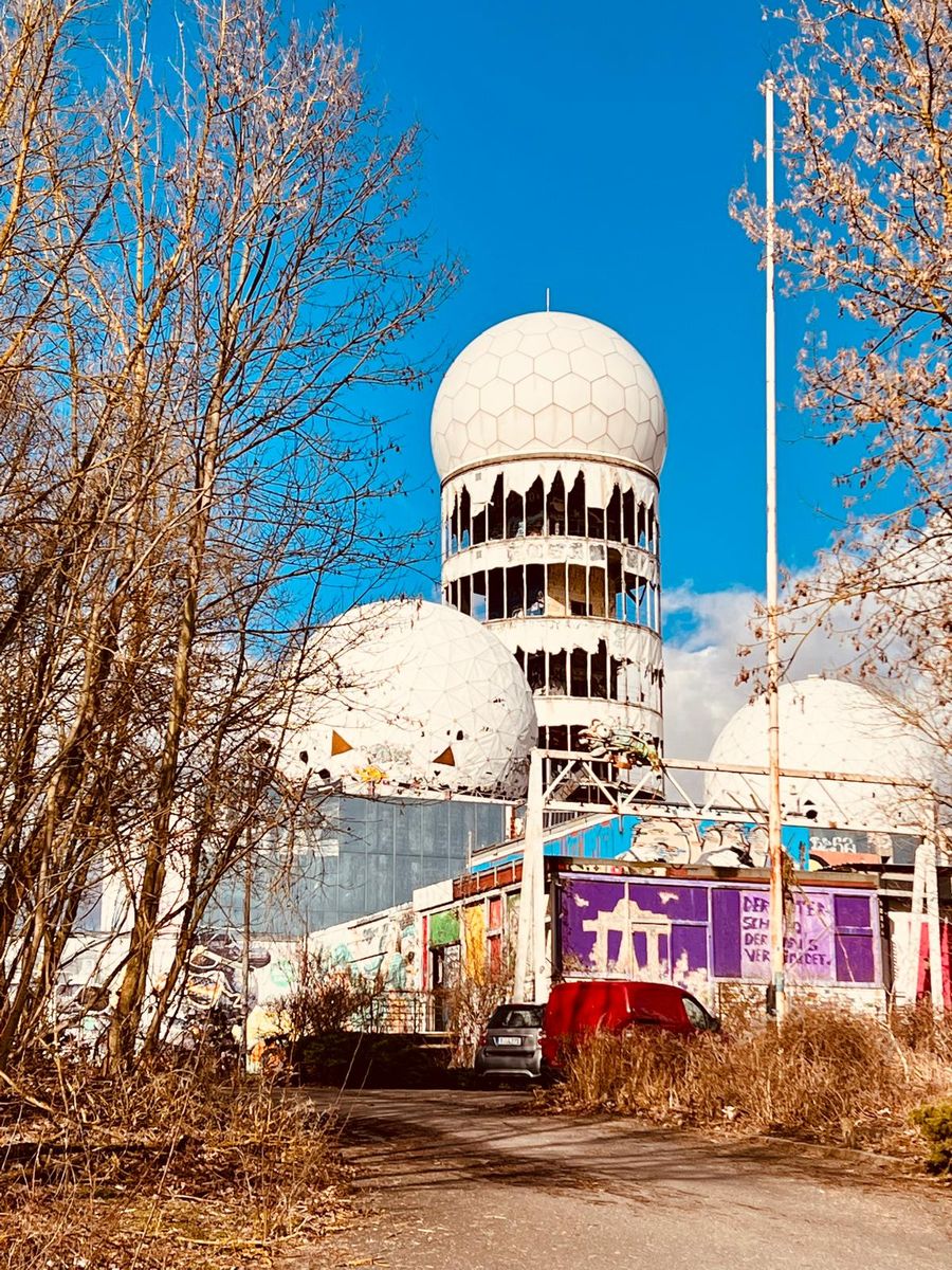 The radar domes of the former listening station on Teufelsberg, Berlin, seen through bare trees